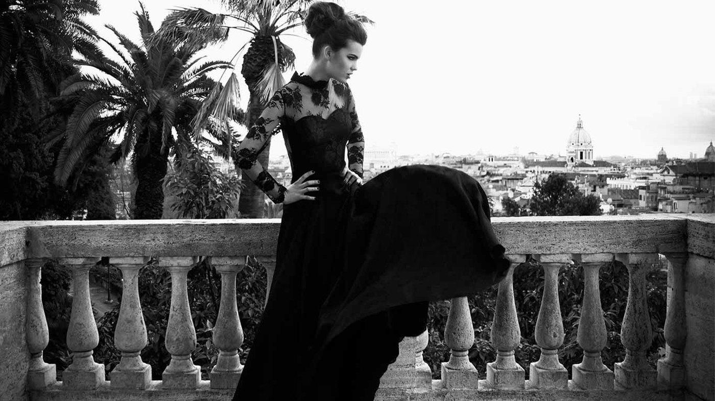 A model in a black couture gown on a Roman terrace overlooking the city