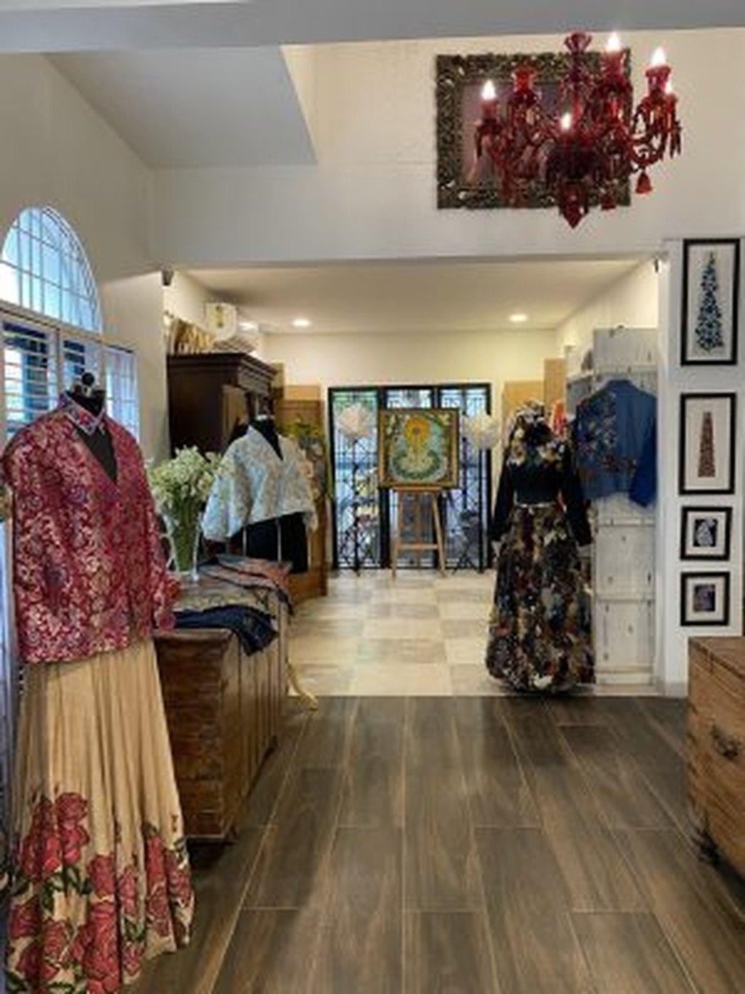 The studio interior, garments arranged on stands
