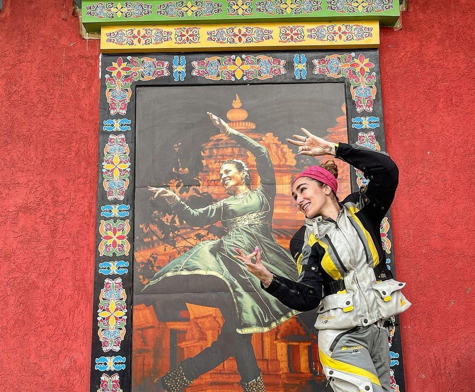 Maral Yazarloo in touring gear beside a painted mural during the Ride To Be One journey